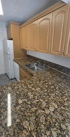 a bathroom with a granite countertop window and a sink