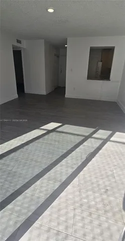 a view of room with window and wooden floor