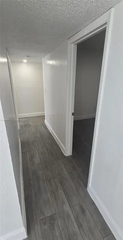a view of hallway with wooden floor