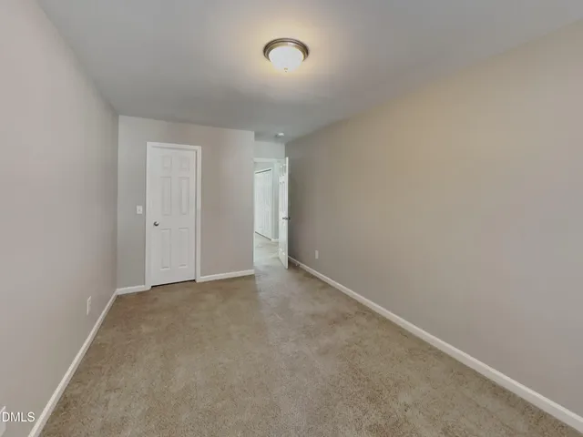 a view of an empty room and a window