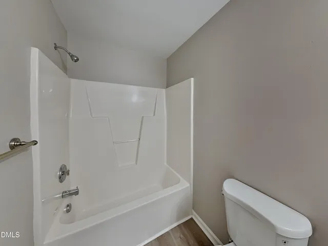 a bathroom with a toilet and a bathtub