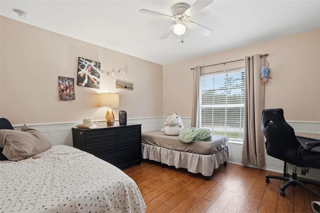 15396 Fleetwood Road Weeki Wachee, FL 34614 - Photo 20 of 66 a bedroom with a bed and wooden floor