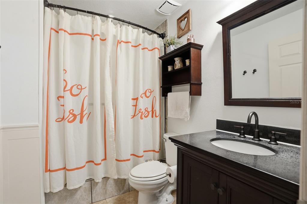 15396 Fleetwood Road Weeki Wachee, FL 34614 - Photo 24 of 66 a bathroom with a granite countertop sink and a mirror