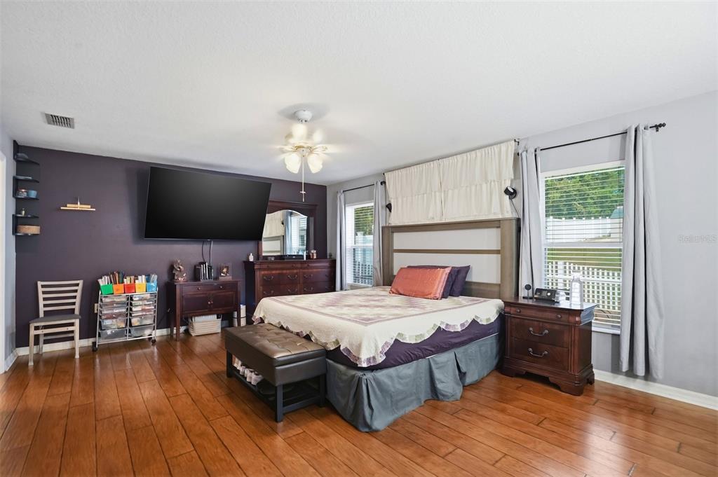 15396 Fleetwood Road Weeki Wachee, FL 34614 - Photo 25 of 66 a bedroom with a bed and a flat screen tv