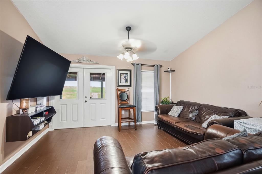 15396 Fleetwood Road Weeki Wachee, FL 34614 - Photo 3 of 66 a living room with furniture and a flat screen tv