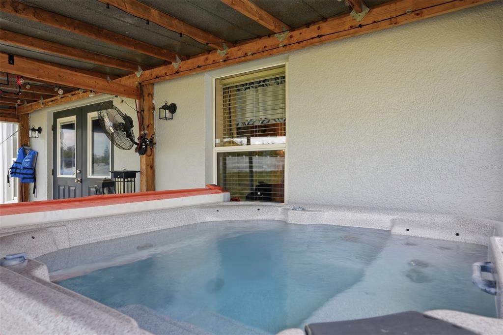 15396 Fleetwood Road Weeki Wachee, FL 34614 - Photo 41 of 66 an empty room with wooden floor and windows