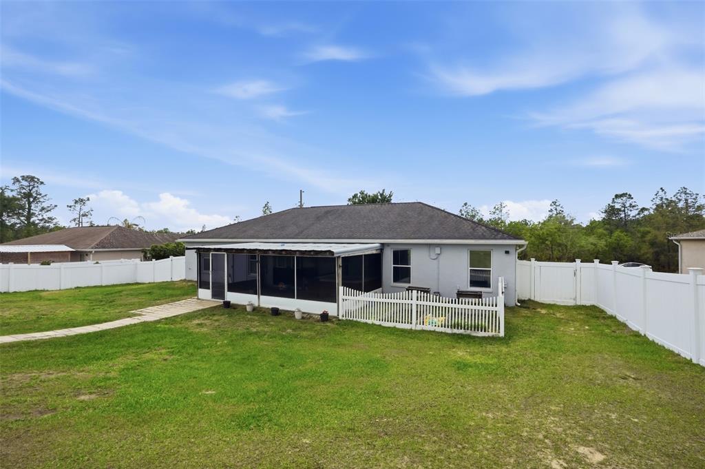 15396 Fleetwood Road Weeki Wachee, FL 34614 - Photo 49 of 66 a view of a house with a backyard porch and sitting area