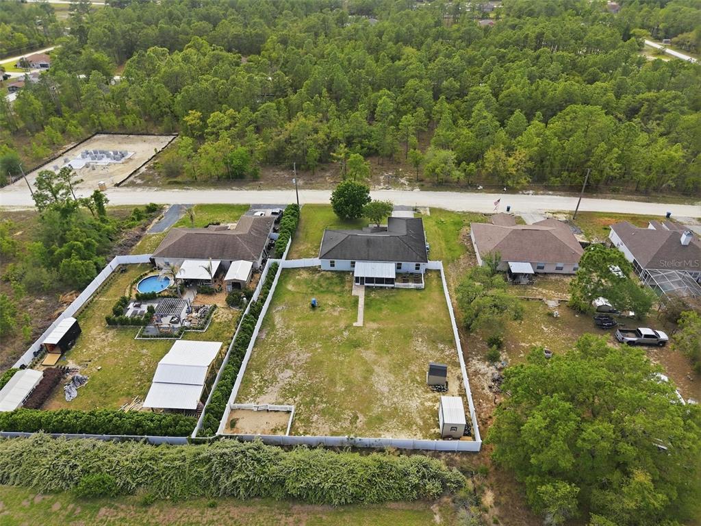 15396 Fleetwood Road Weeki Wachee, FL 34614 - Photo 57 of 66 an aerial view of a house with swimming pool and tennis court