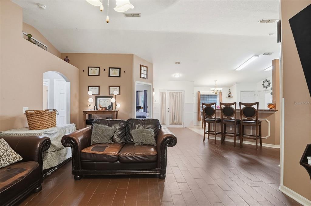 15396 Fleetwood Road Weeki Wachee, FL 34614 - Photo 6 of 66 a living room with furniture kitchen view and a wooden floor