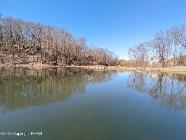 a view of a lake with houses in the back