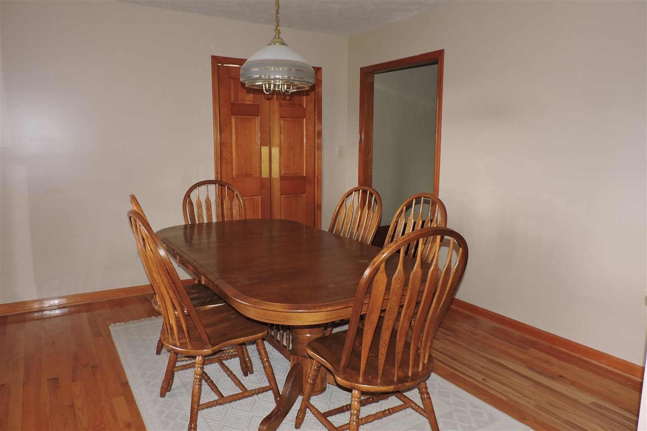 266 McKinley Road Middlebrook, VA 24459 - Photo 17 of 28 a dining room with furniture wooden floor a rug and a chandelier