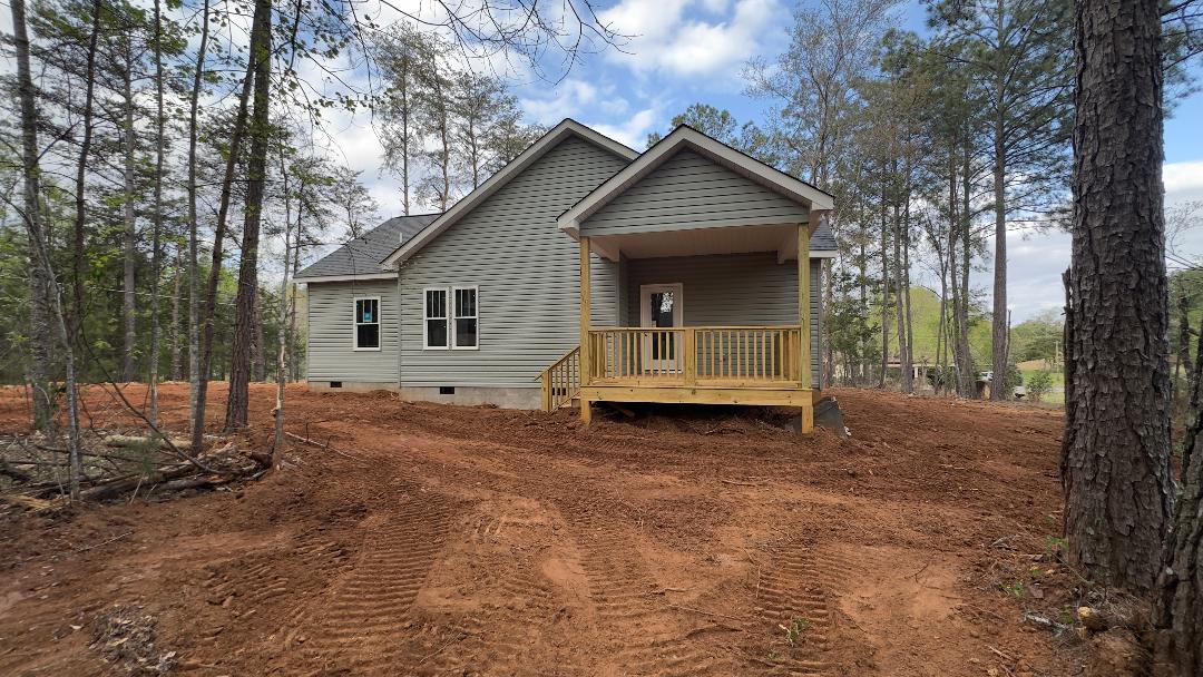 247 Vera Holliday Road Six Mile, SC 29682 - Photo 18 of 20 This newly constructed residence features a charming covered porch, offering a tranquil retreat amidst a wooded landscape.