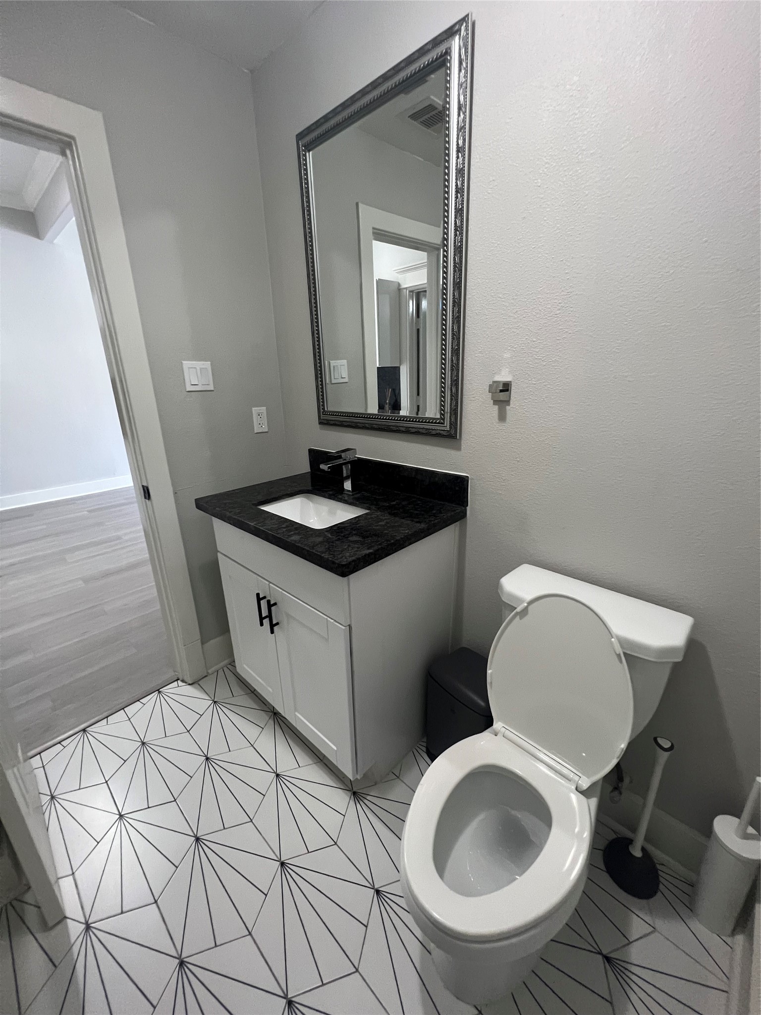 220 Redan Street, Unit A Houston, TX 77009 - Photo 13 of 22 a bathroom with a toilet sink and mirror