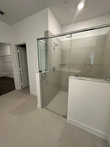 a bathroom with a glass shower door