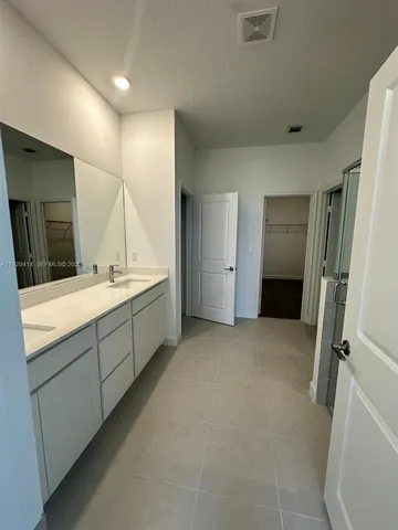 a bathroom with a double vanity sink a and mirror