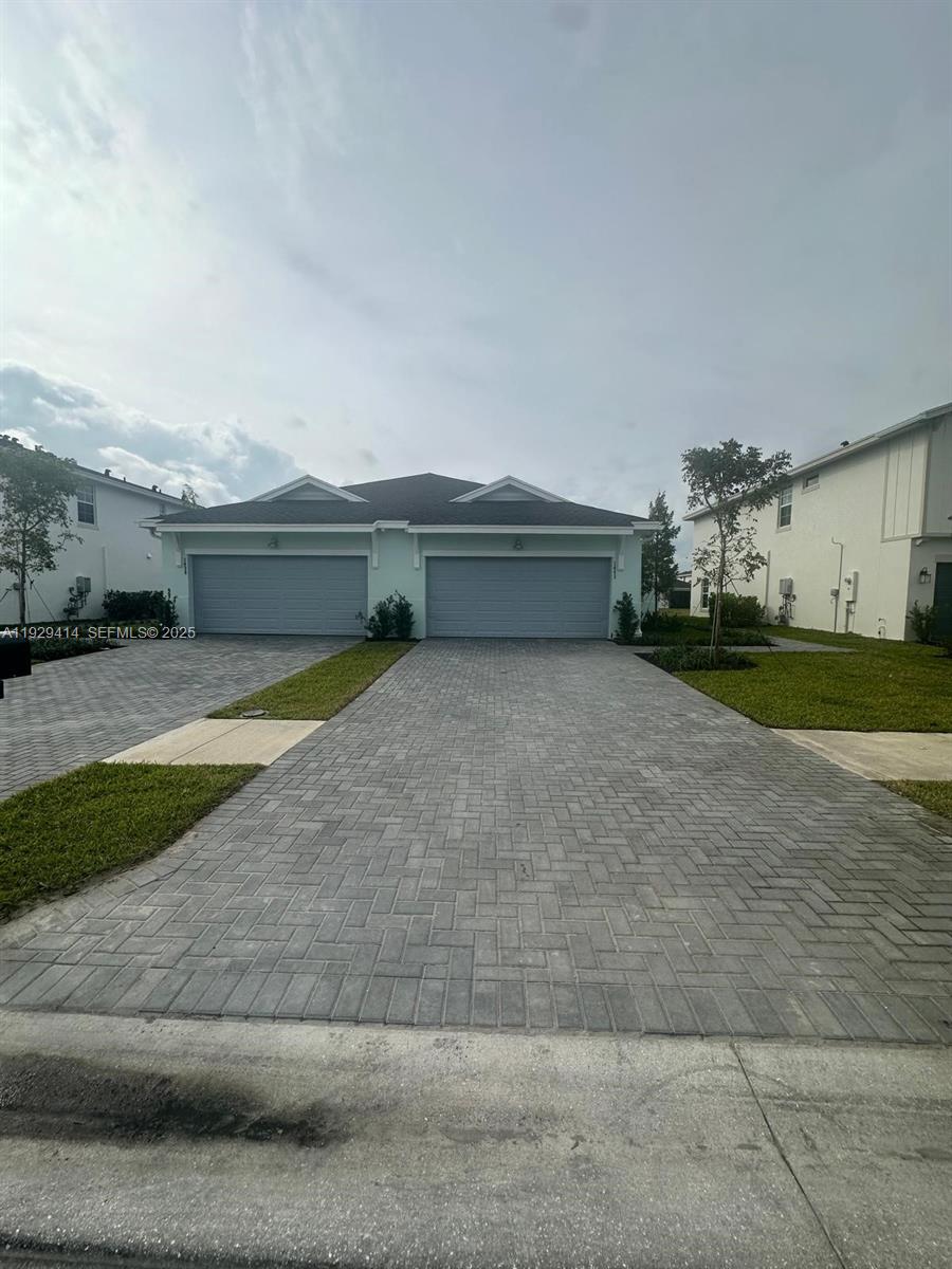 1443 Tangled Orchard Trace, Unit 1443 Loxahatchee, FL 33470 - Photo 2 of 33 a view of backyard with large trees