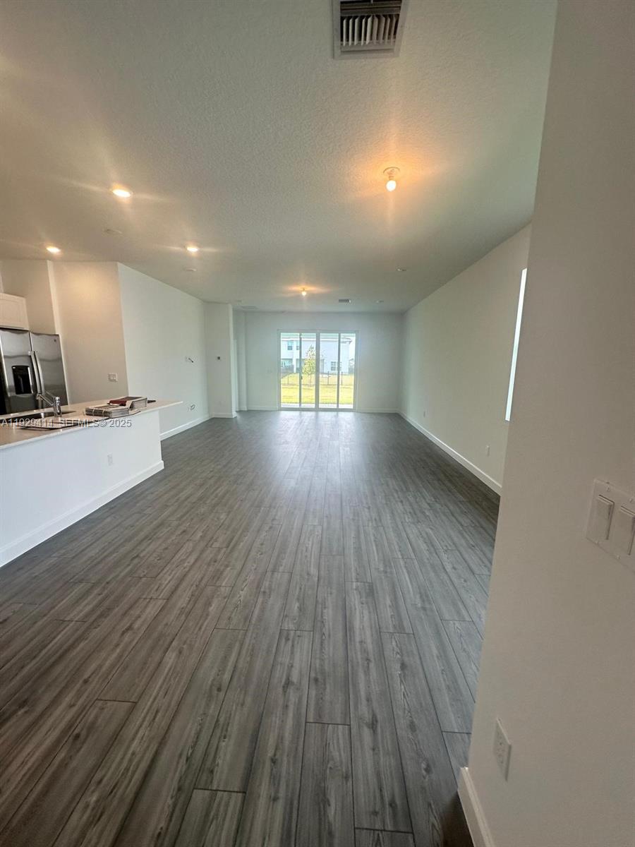 1443 Tangled Orchard Trace, Unit 1443 Loxahatchee, FL 33470 - Photo 27 of 33 a view of an empty room with wooden floor and a window