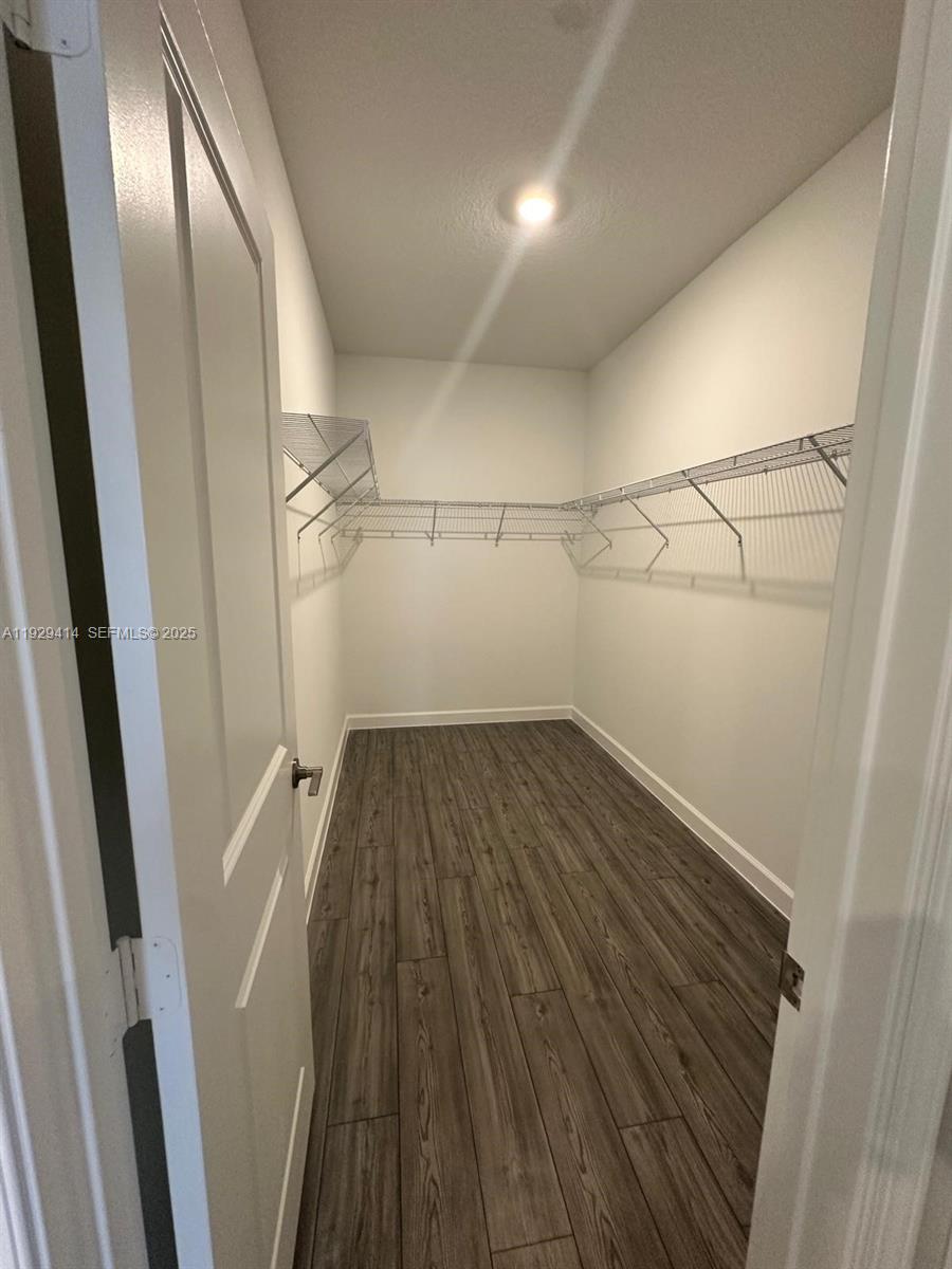 1443 Tangled Orchard Trace, Unit 1443 Loxahatchee, FL 33470 - Photo 28 of 33 a view of a hallway with wooden floor