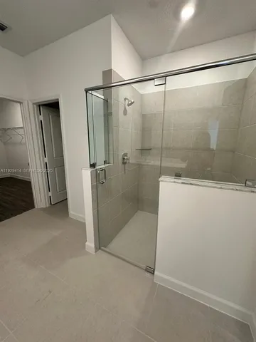 a bathroom with a glass shower door