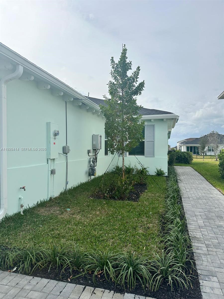 1443 Tangled Orchard Trace, Unit 1443 Loxahatchee, FL 33470 - Photo 3 of 33 a front view of a house with garden