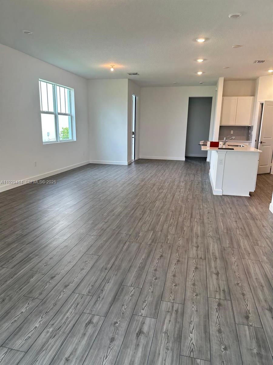 1443 Tangled Orchard Trace, Unit 1443 Loxahatchee, FL 33470 - Photo 5 of 33 an empty room with wooden floor and windows