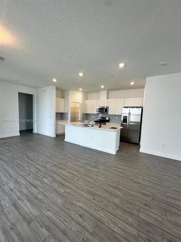 a view of kitchen with kitchen island microwave and stove
