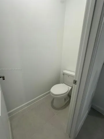a white toilet sitting next to a sink