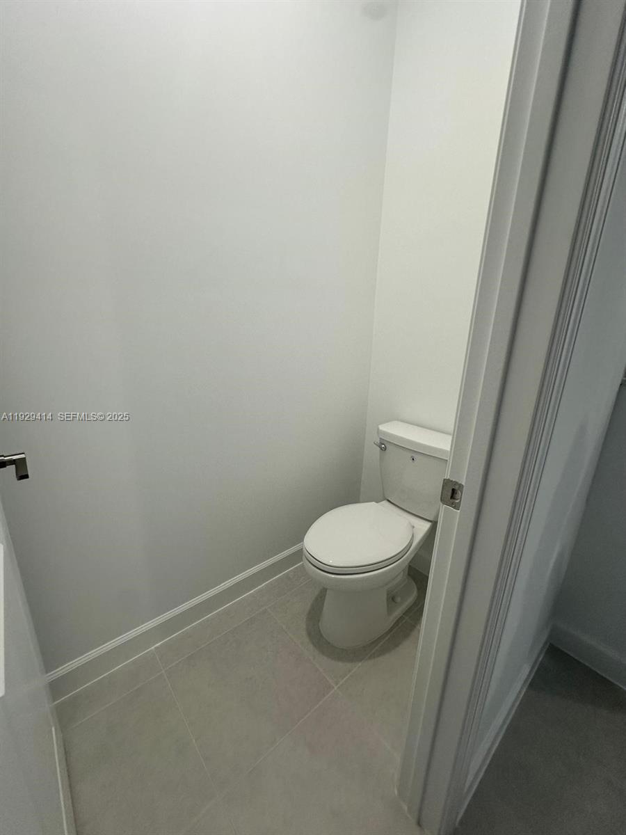 1443 Tangled Orchard Trace, Unit 1443 Loxahatchee, FL 33470 - Photo 8 of 33 a white toilet sitting next to a sink