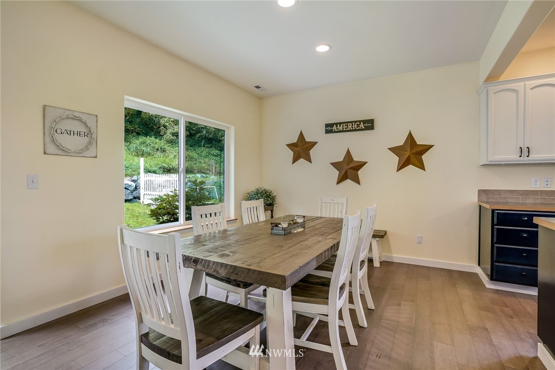 5910 Larimer Road, Unit A Everett, WA 98208 - Photo 12 of 24 a view of a dining room with furniture window and wooden floor