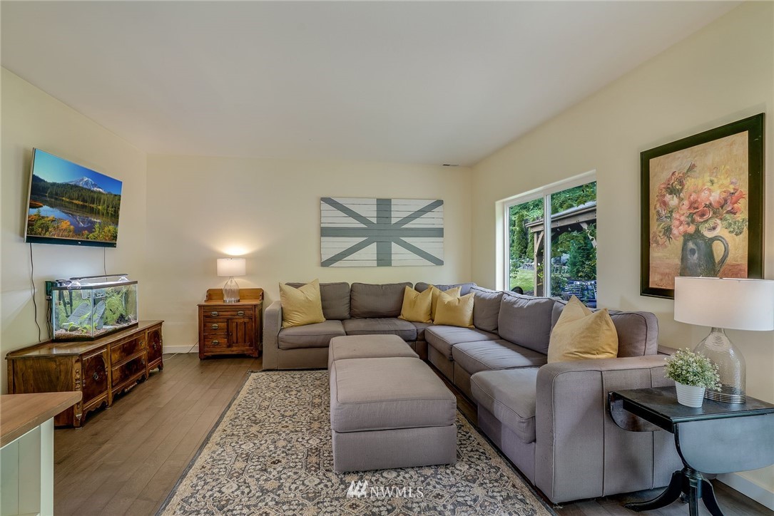 5910 Larimer Road, Unit A Everett, WA 98208 - Photo 13 of 24 a living room with furniture and a flat screen tv