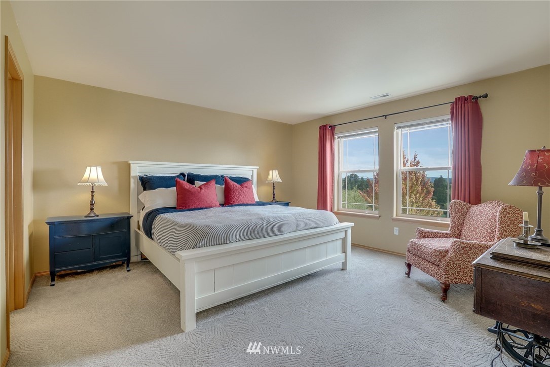 5910 Larimer Road, Unit A Everett, WA 98208 - Photo 15 of 24 a bed sitting in a bedroom next to a window