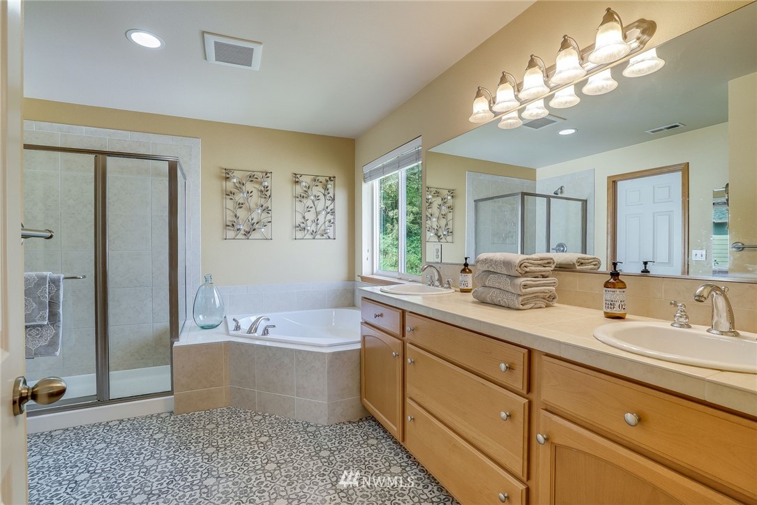 5910 Larimer Road, Unit A Everett, WA 98208 - Photo 16 of 24 a spacious bathroom with a tub sink and mirror