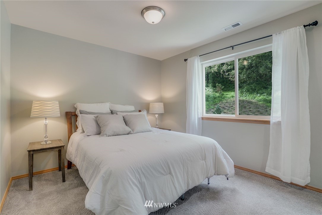 5910 Larimer Road, Unit A Everett, WA 98208 - Photo 17 of 24 a bedroom with a bed and a window
