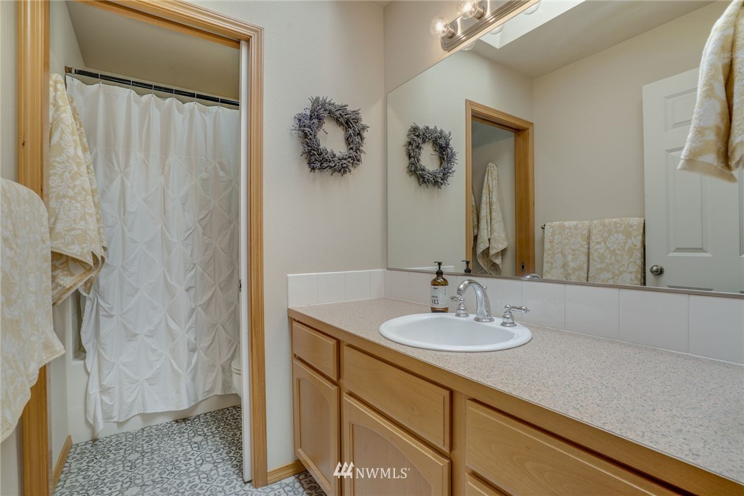 5910 Larimer Road, Unit A Everett, WA 98208 - Photo 18 of 24 a bathroom with a sink and a mirror