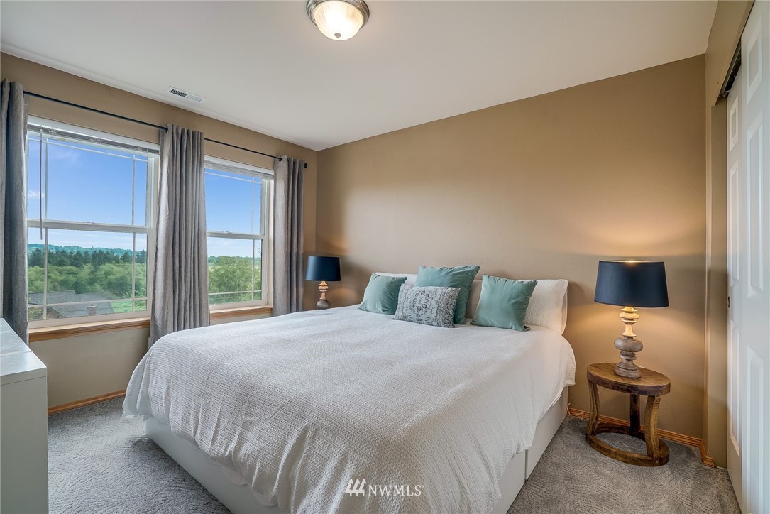 5910 Larimer Road, Unit A Everett, WA 98208 - Photo 19 of 24 a large bed sitting in a bedroom next to a window