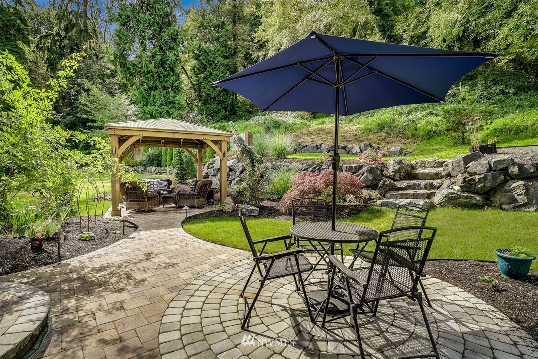 5910 Larimer Road, Unit A Everett, WA 98208 - Photo 20 of 24 a view of table and chairs under an umbrella