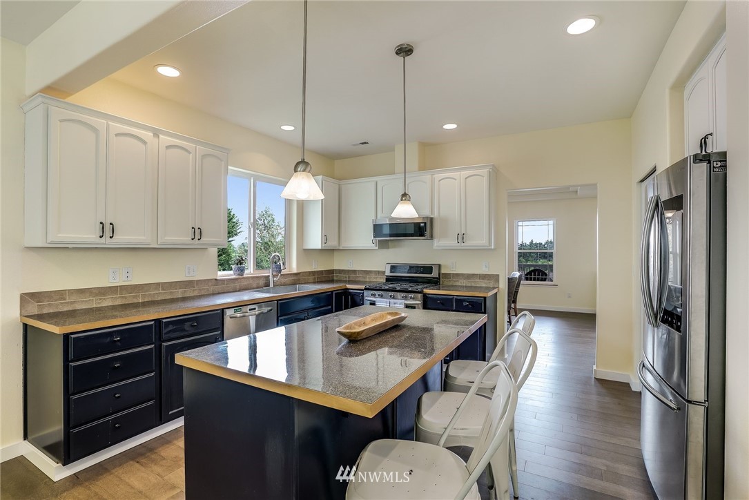 5910 Larimer Road, Unit A Everett, WA 98208 - Photo 10 of 24 a kitchen with a refrigerator a sink and wooden floor