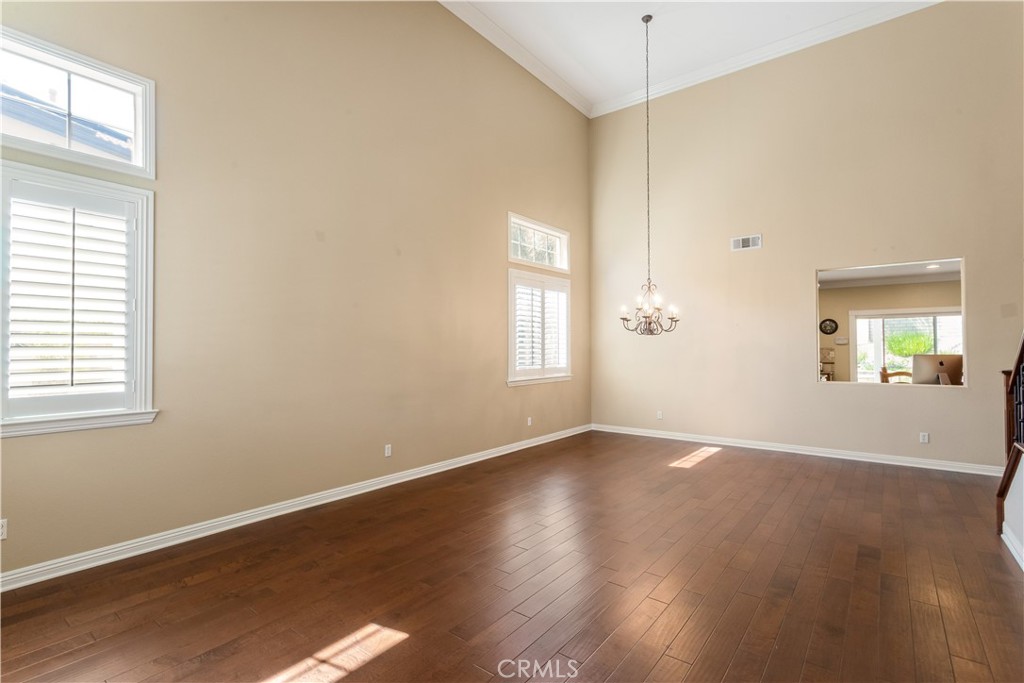 33351 Nicholas Common Temecula, CA 92592 - Photo 9 of 42 an empty room with wooden floor and windows