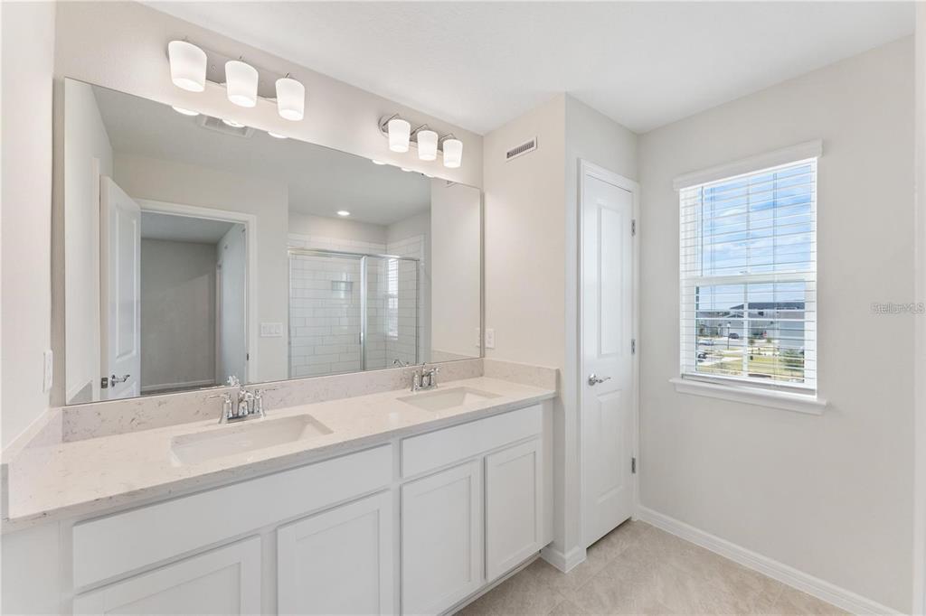 2326 Vision Street Davenport, FL 33896 - Photo 19 of 29 a bathroom with double sink and a mirror