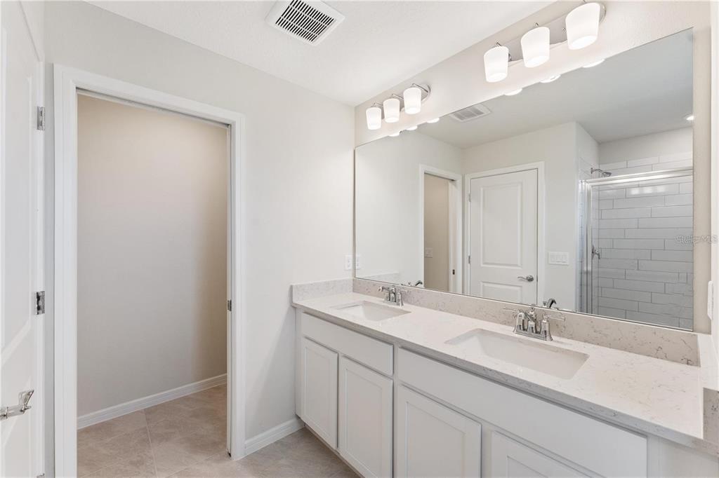 2326 Vision Street Davenport, FL 33896 - Photo 21 of 29 a bathroom with a sink double vanity and a mirror