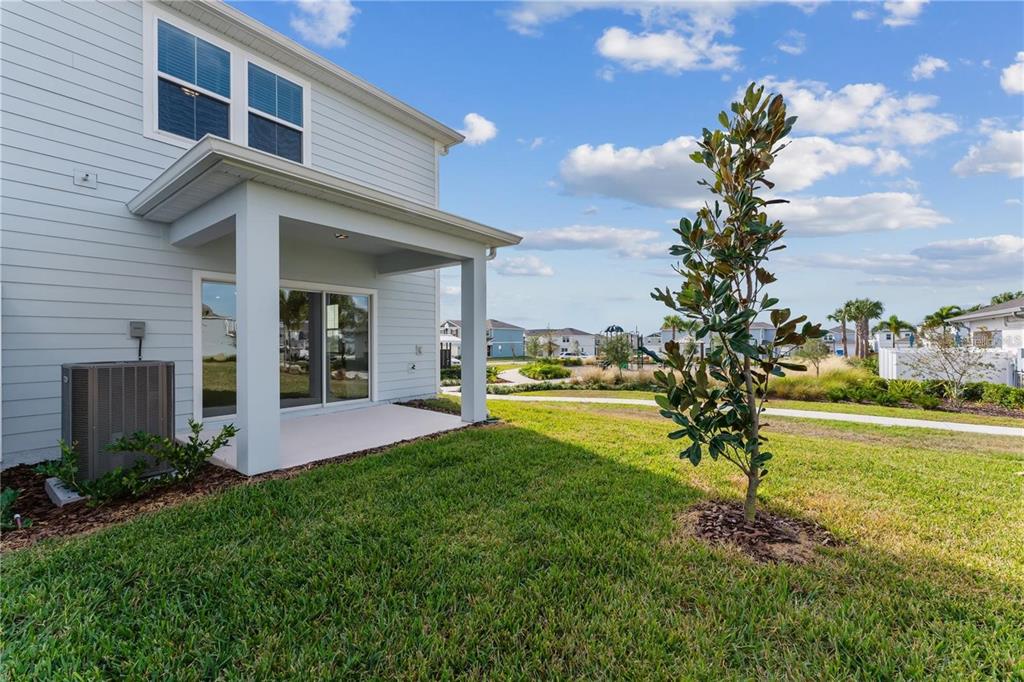 2326 Vision Street Davenport, FL 33896 - Photo 27 of 29 a view of a house with a yard and a garden