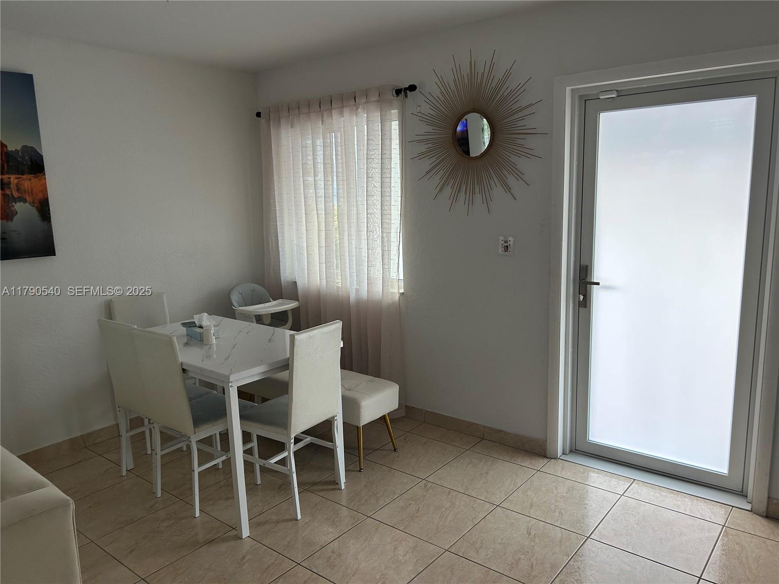 1446 Northwest 61st Street Miami, FL 33142 - Photo 11 of 54 a view of a dining room with furniture and window