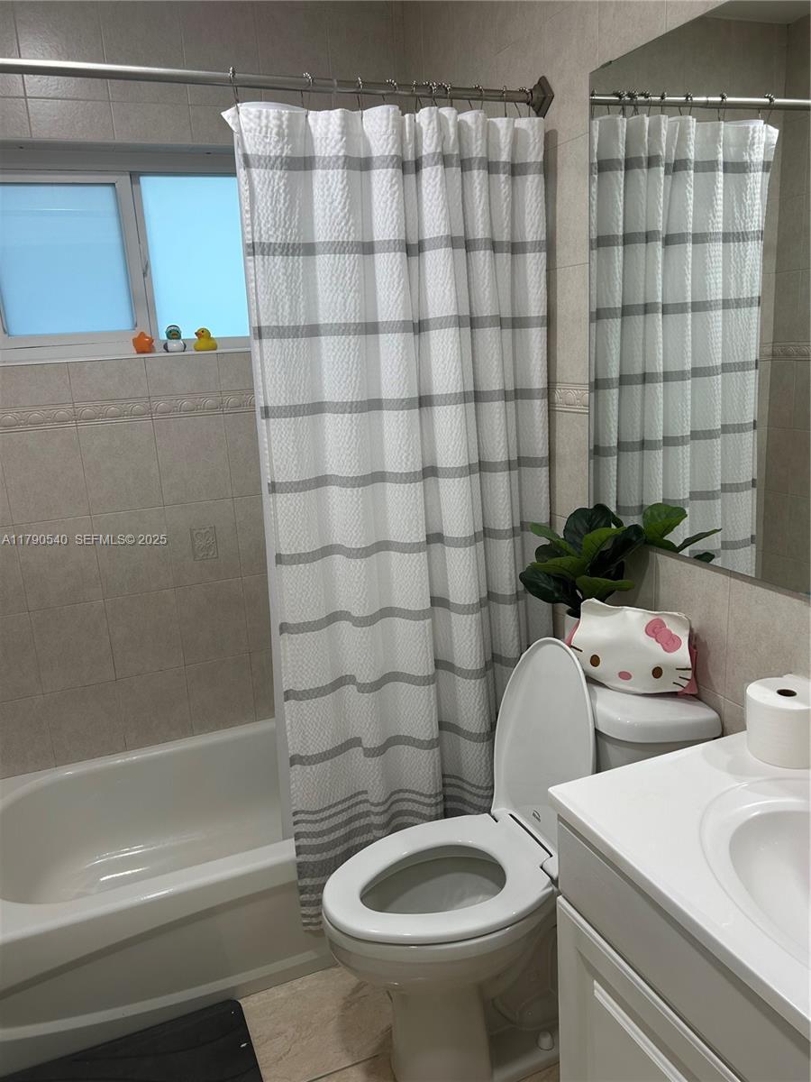 1446 Northwest 61st Street Miami, FL 33142 - Photo 13 of 54 a bathroom with a sink a toilet and shower