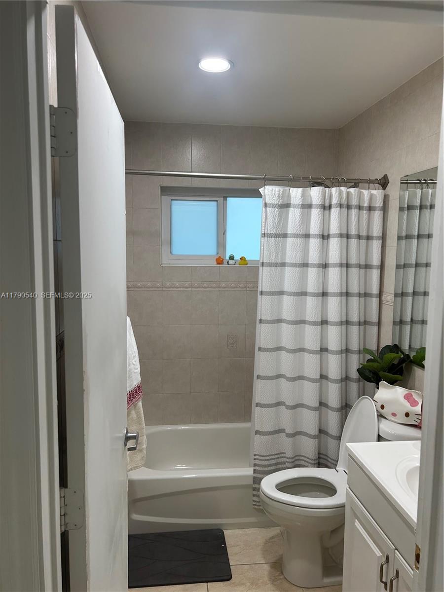 1446 Northwest 61st Street Miami, FL 33142 - Photo 16 of 54 a bathroom with a sink a toilet and shower