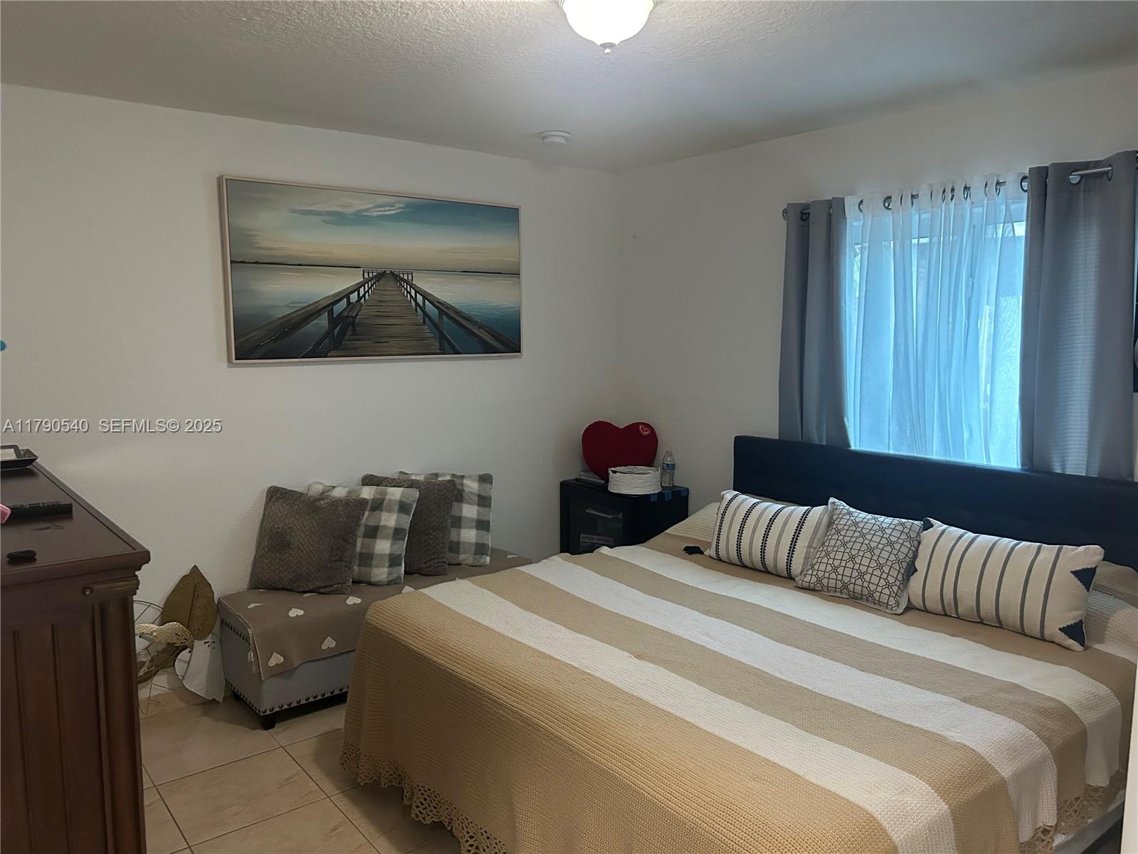 1446 Northwest 61st Street Miami, FL 33142 - Photo 17 of 54 a bedroom with a bed and wooden floor