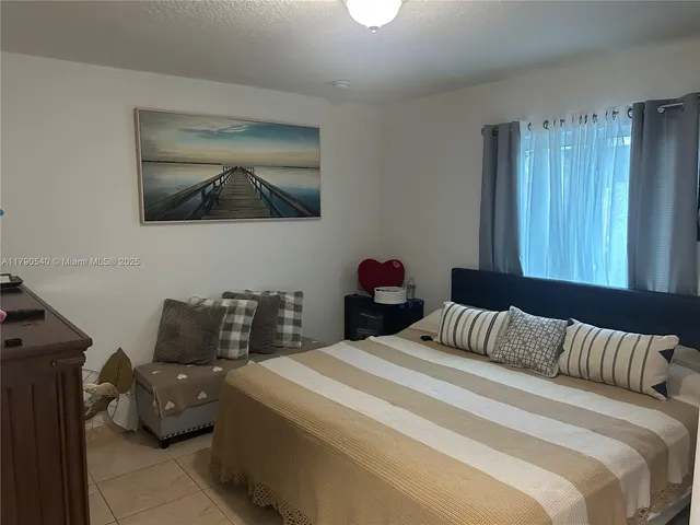 a living room with a dresser and a flat screen tv