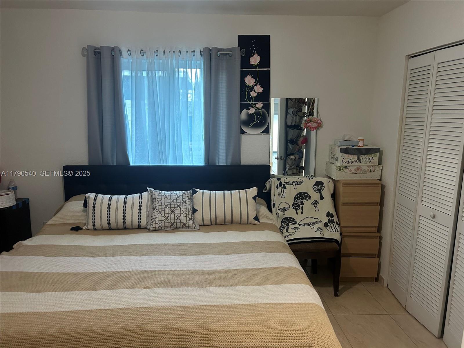 1446 Northwest 61st Street Miami, FL 33142 - Photo 18 of 54 a bedroom with a bed and a window