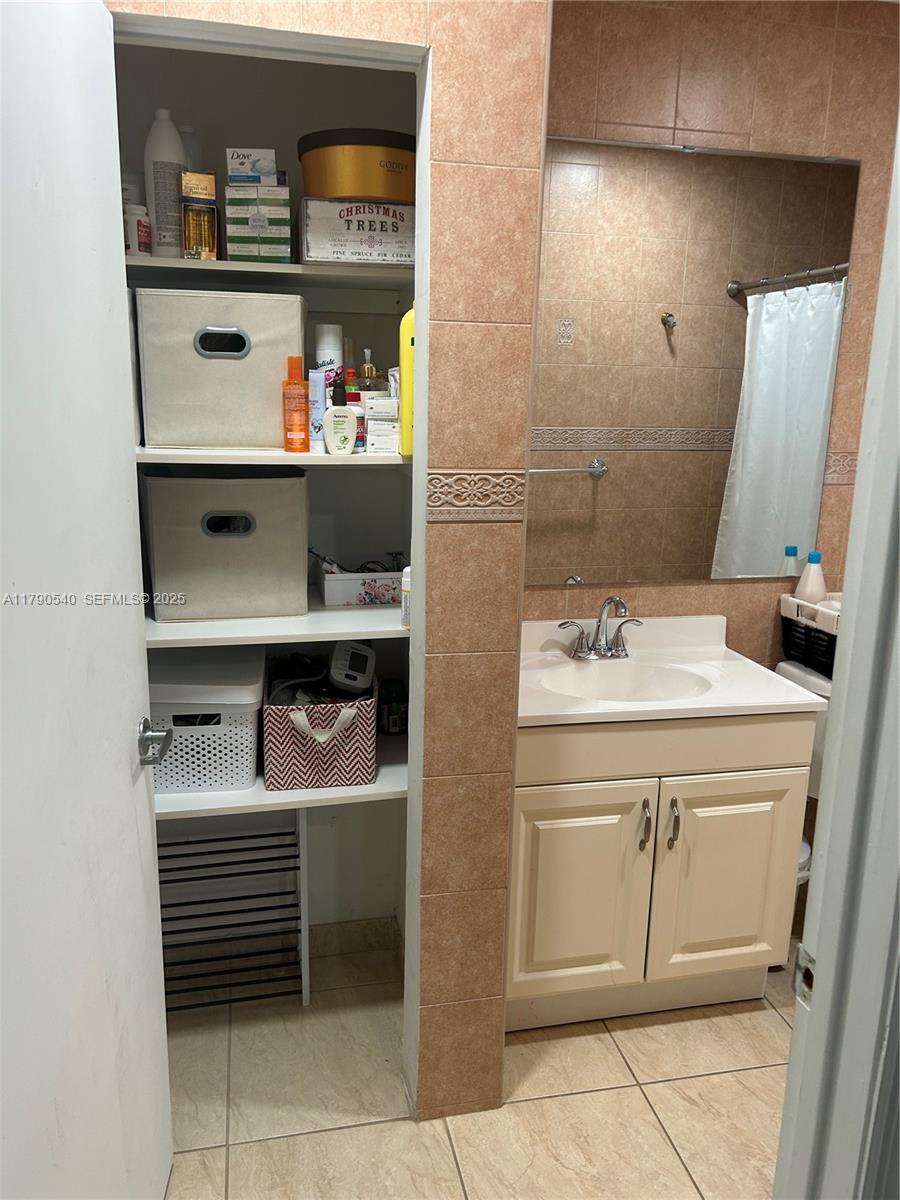 1446 Northwest 61st Street Miami, FL 33142 - Photo 21 of 54 a bathroom with a sink and a mirror