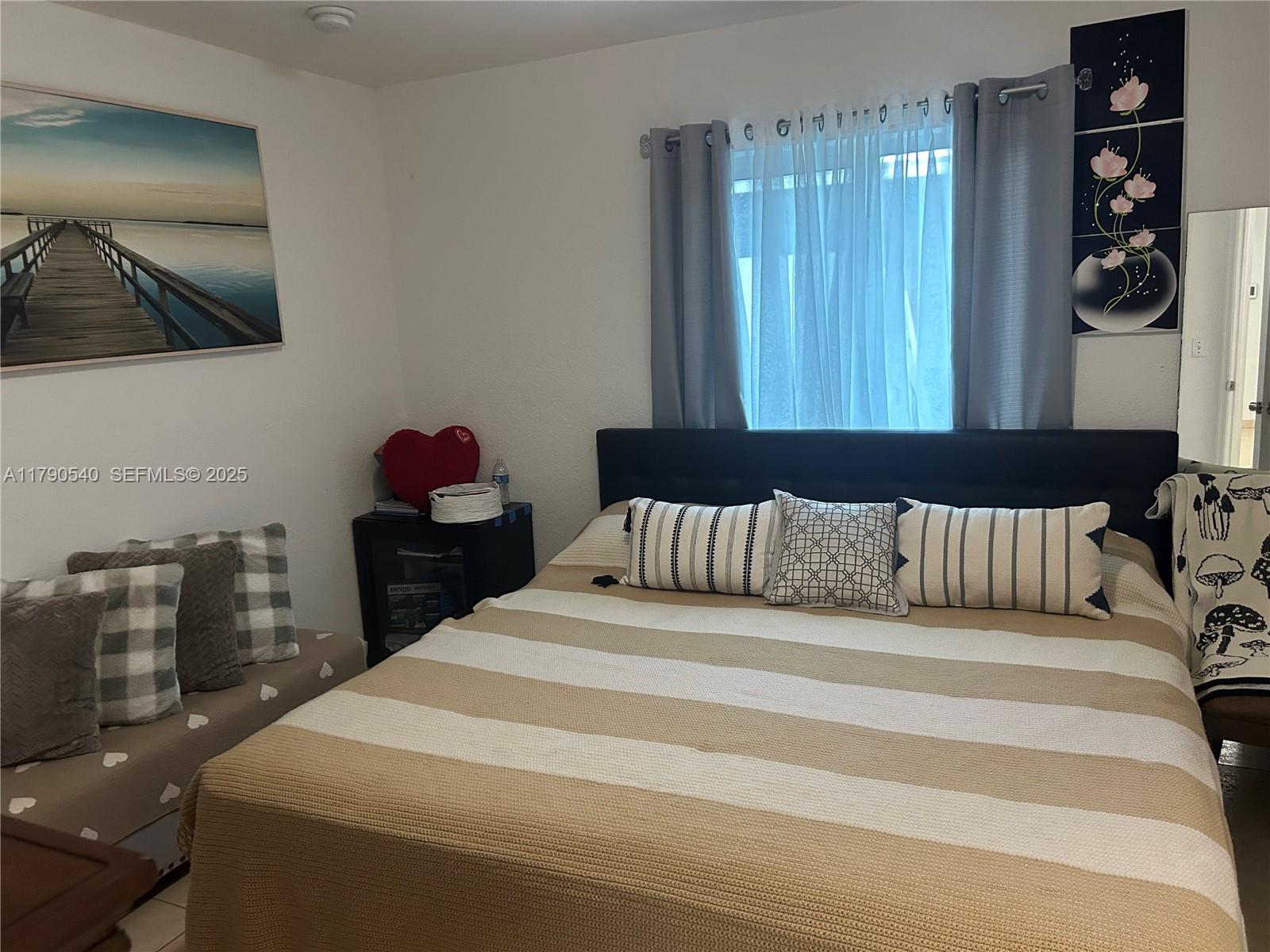 1446 Northwest 61st Street Miami, FL 33142 - Photo 22 of 54 a bedroom with a bed and a mirror