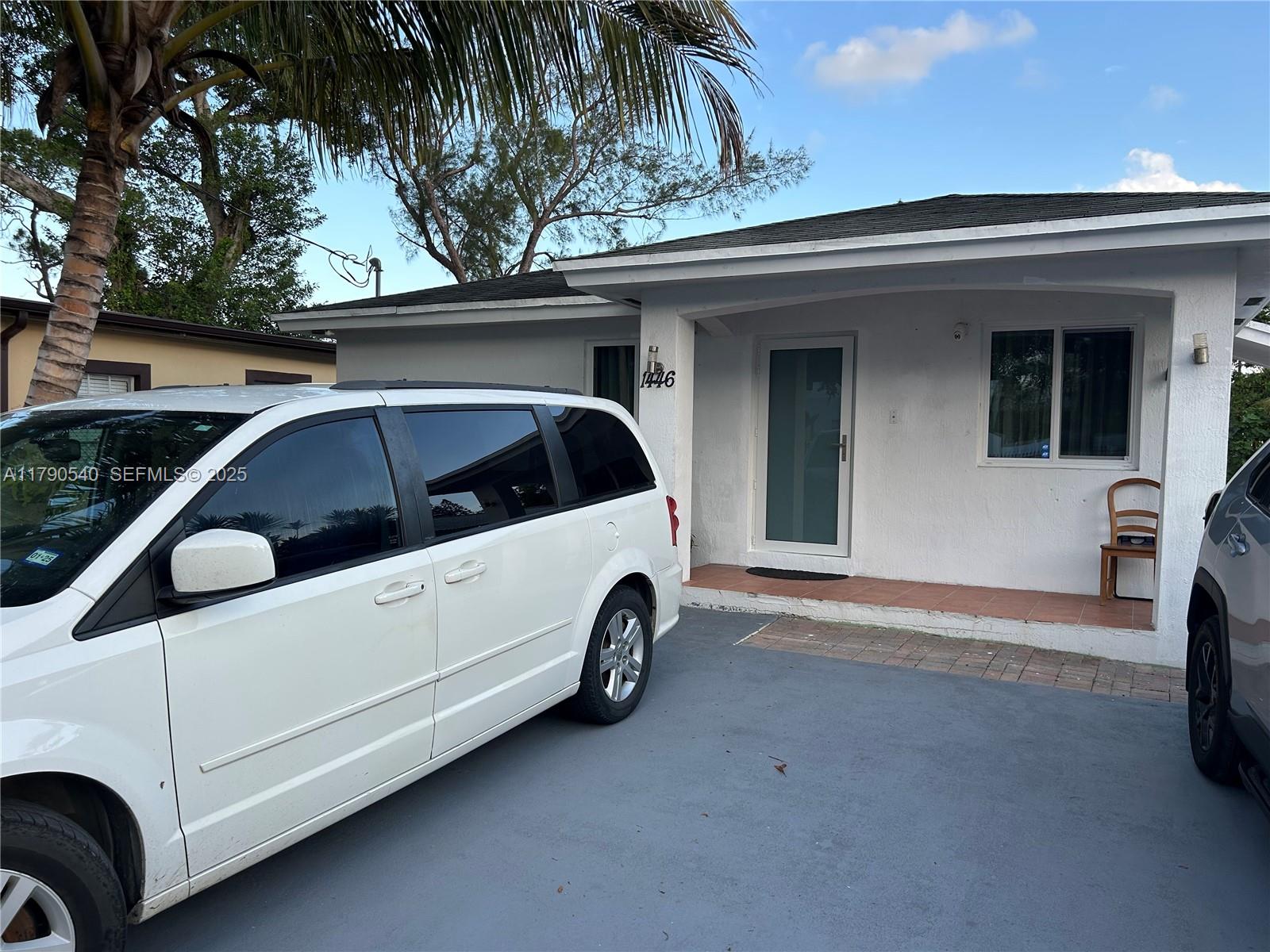 1446 Northwest 61st Street Miami, FL 33142 - Photo 3 of 54 a view of a car in back of house